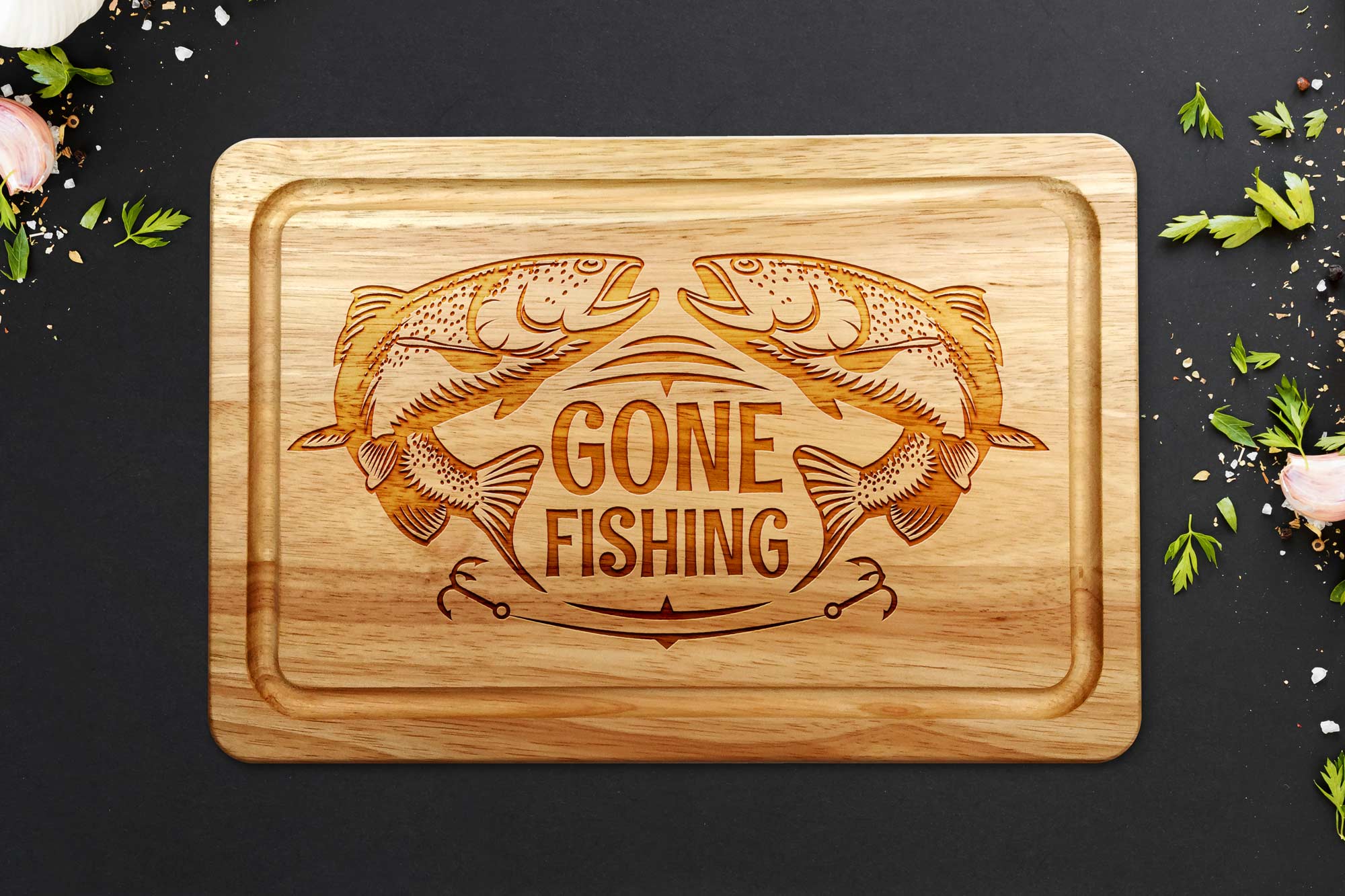 Gone Fishing chopping board on a grey worktop