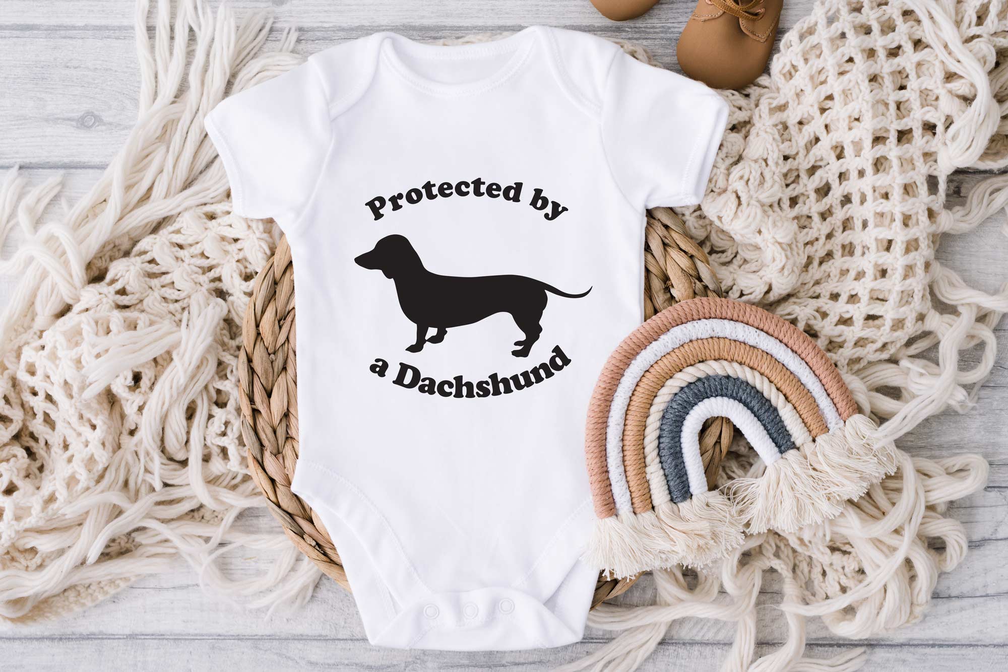 protected by a Dachshund white onesie