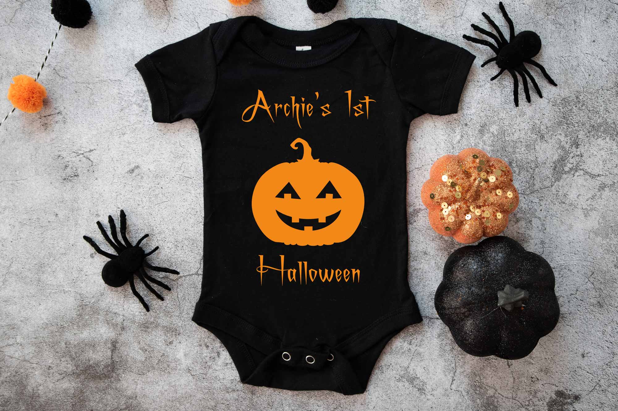 Black baby's first halloween onesie on a spooky background