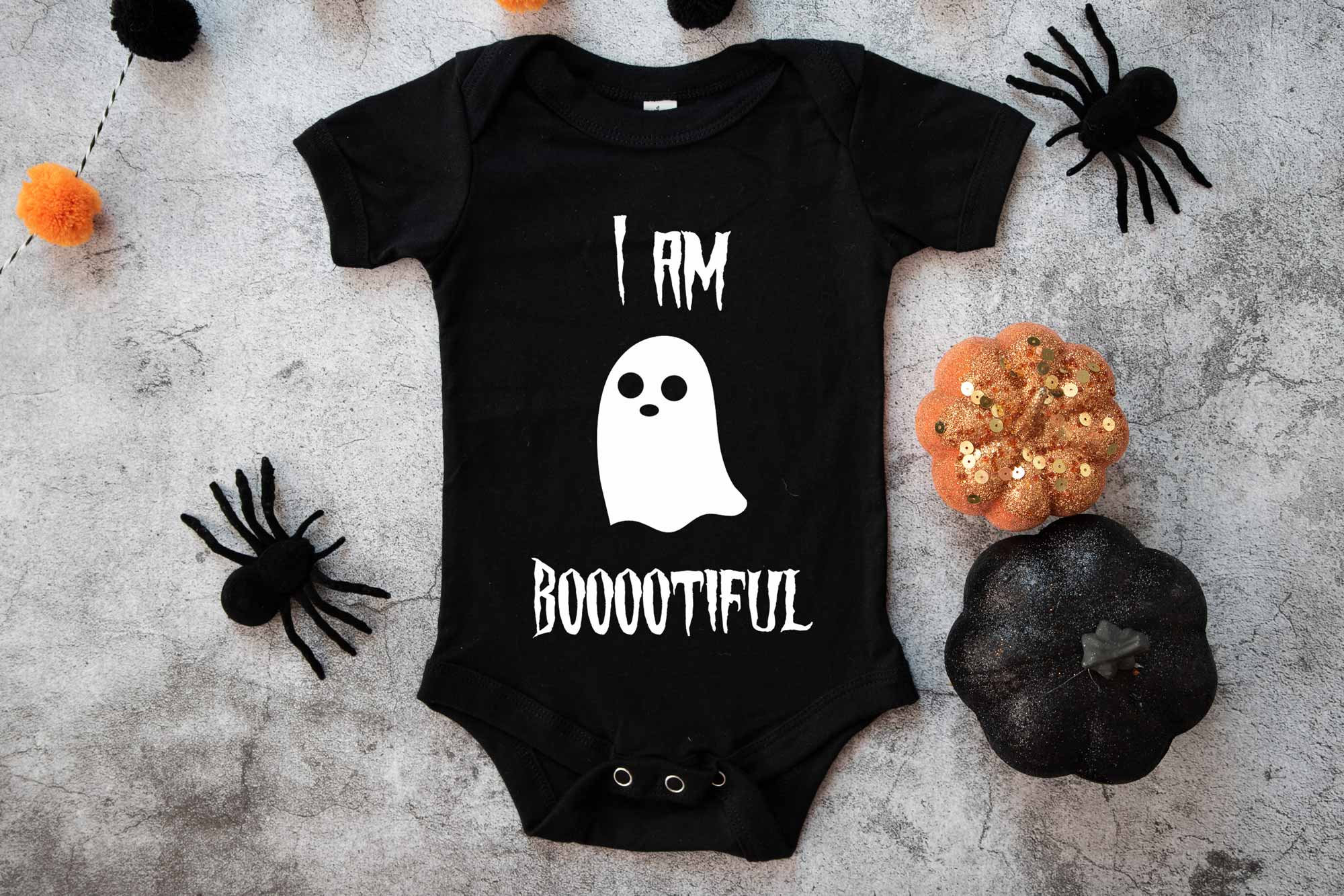 I am bootiful halloween baby onesie on a spooky background